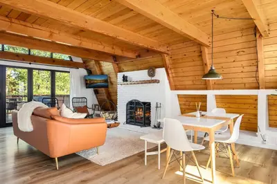 a living room with a couch and a fireplace at Midnight Chalet Big Bear Lake in Big Bear Lake