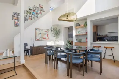 a dining room with a table and blue chairs at Pacific Breeze - Modern Venice Beach Home in Los Angeles