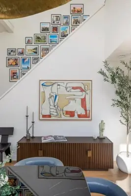 a living room with a table and a staircase at Pacific Breeze - Modern Venice Beach Home in Los Angeles