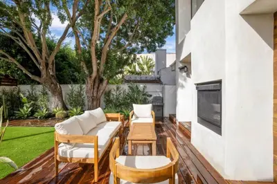 a patio with a couch and chairs and a table at Pacific Breeze - Modern Venice Beach Home in Los Angeles