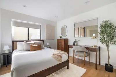 a bedroom with a bed and a desk at Pacific Breeze - Modern Venice Beach Home in Los Angeles