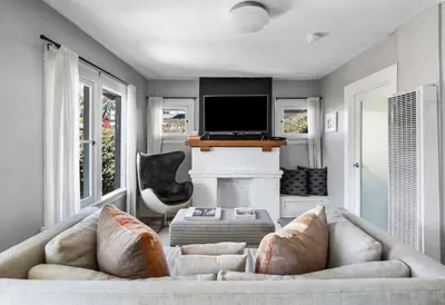 a living room with a couch and a fireplace at Venice Gem Private Beach Bungalow in Los Angeles