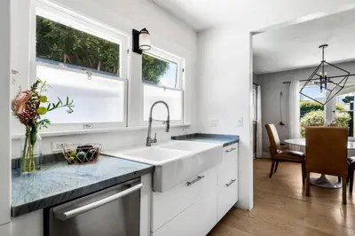 a white kitchen with a sink and a window at Venice Gem Private Beach Bungalow in Los Angeles