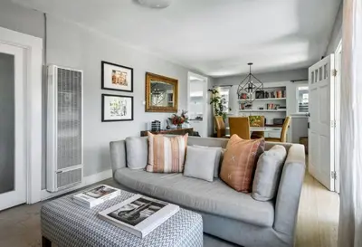 a living room with a couch and a table at Venice Gem Private Beach Bungalow in Los Angeles