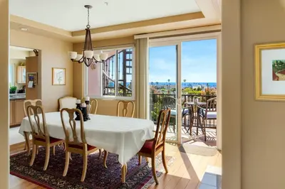 a dining room with a table and chairs and a balcony at Oceanview Coastal Retreat in Redondo Beach in Redondo Beach