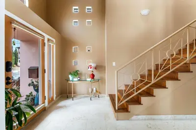 a hallway with a staircase in a house at Oceanview Coastal Retreat in Redondo Beach in Redondo Beach