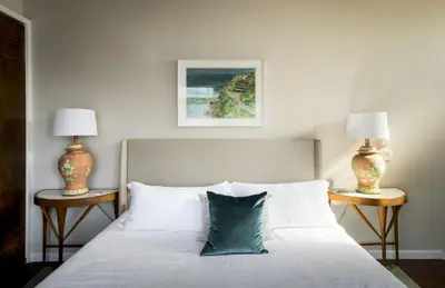a bedroom with a bed with two lamps on two tables at New Listing The Nautilus Manhattan Beachfront Retreat in Manhattan Beach