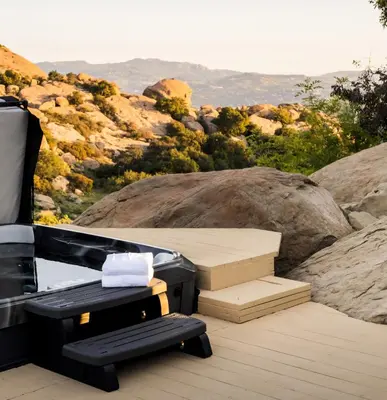 a hot tub on a deck with a view of a mountain at Retreat to the Rocks Historic Film And Music Getaway in Chatsworth Lake Manor