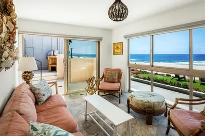 a living room with a view of the ocean at New The Triton Manhattan Beachfront Escape in Manhattan Beach