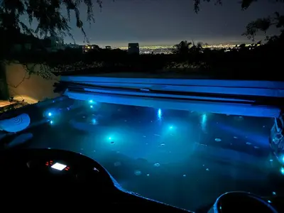 a swimming pool at night with blue lights at Bella Villa near Beverly Hills Amazing City view and hot tub in Los Angeles