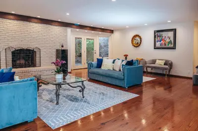 a living room with blue furniture and a fireplace at Bella Villa near Beverly Hills Amazing City view and hot tub in Los Angeles