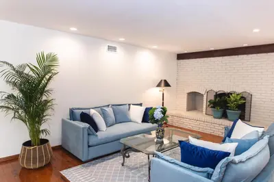 a living room with blue couches and a fireplace at Bella Villa near Beverly Hills Amazing City view and hot tub in Los Angeles