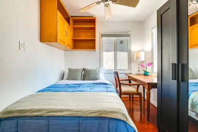 a small bedroom with a bed and a desk at Steps to Ocean Manhattan Beach Gem with Deck! in Manhattan Beach