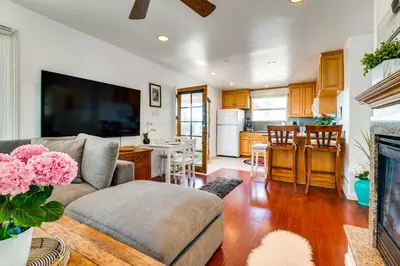 a living room with a couch and a kitchen at Steps to Ocean Manhattan Beach Gem with Deck! in Manhattan Beach