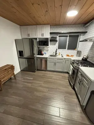 a kitchen with white cabinets and stainless steel appliances at The Honey Bear Cabin Jacuzzi EV Friendly Renovated in Green Valley Lake