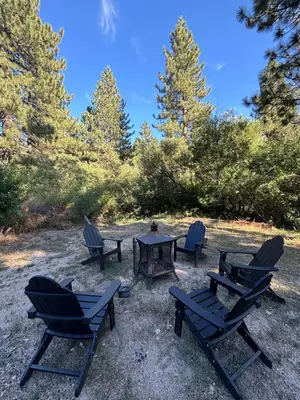 a group of chairs and a table and a picnic table at The Honey Bear Cabin Jacuzzi EV Friendly Renovated in Green Valley Lake