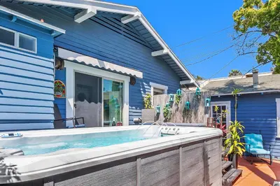 a blue house with a hot tub in front of it at Spa, Parking, King Bd, Desk, 7 Min Walk to Beach in Long Beach