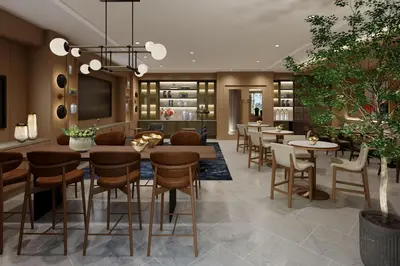 a lobby with tables and chairs in a restaurant at Hilton Arcadia Los Angeles in Arcadia