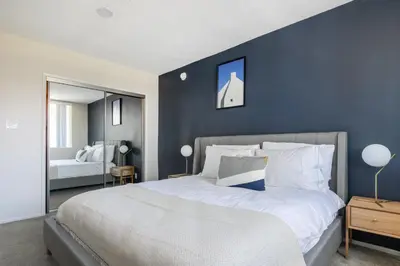 a bedroom with a large bed with a blue wall at Brentwood 2BR w Outdoor Pool nr shops LAX-146 in Los Angeles