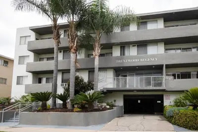 a building with palm trees in front of it at Brentwood 2BR w Outdoor Pool nr shops LAX-146 in Los Angeles