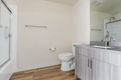 a white bathroom with a toilet and a sink at Blueground Venice pool wd nr beach LAX-1329 in Los Angeles