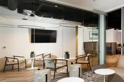 a meeting room with tables and chairs and aktop at Blueground Venice pool wd nr beach LAX-1329 in Los Angeles
