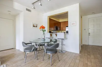 a dining room with a glass table and chairs at Blueground Playa Vista pool AC nr beach LAX-1353 in Los Angeles