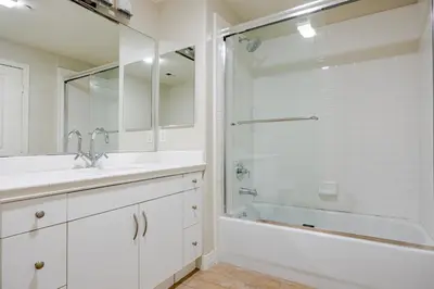 a white bathroom with a shower and a sink at Blueground Playa Vista pool AC nr beach LAX-1353 in Los Angeles