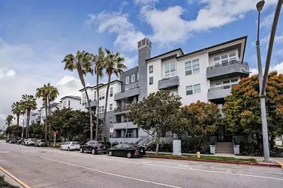 a street with cars parked in front of a building at Blueground Playa Vista pool AC nr beach LAX-1353 in Los Angeles