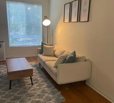a living room with a couch and a coffee table at LALAs House- 1br with Free Parking, Pool and Sauna in Los Angeles
