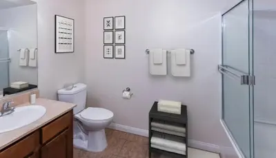 a bathroom with a toilet and a shower and a sink at LALAs House- 1br with Free Parking, Pool and Sauna in Los Angeles
