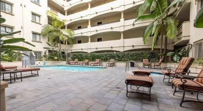 a courtyard with a swimming pool in a building at LALAs House- 1br with Free Parking, Pool and Sauna in Los Angeles