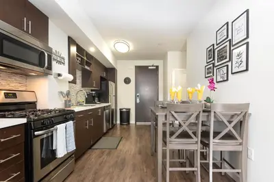 a kitchen with a counter and a bar with stools at Vista Point Suites in Los Angeles