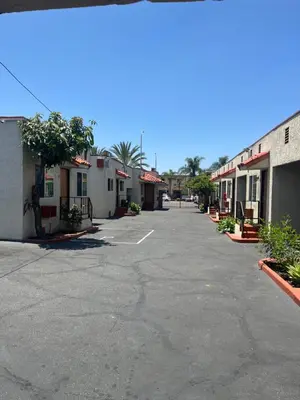 an empty parking lot in a town with buildings at World Motel in Lynwood