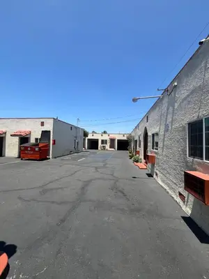 an empty parking lot next to a building at World Motel in Lynwood