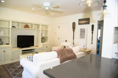 a living room with a white couch and a tv at 4980 Sandyland Road #216 in Carpinteria