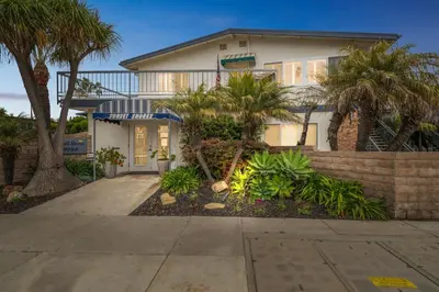 a house with palm trees in front of it at 4980 Sandyland Road #216 in Carpinteria
