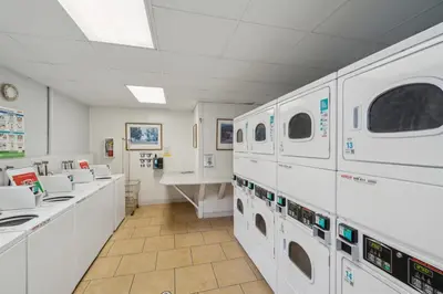 a laundry room with washing machines and a counter at 4980 Sandyland Road #216 in Carpinteria