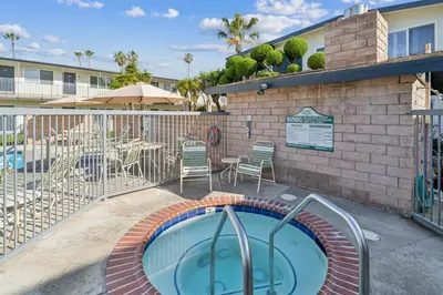 a swimming pool with a patio and a table and chairs at Beach Condo with Private Patio #133 in Carpinteria
