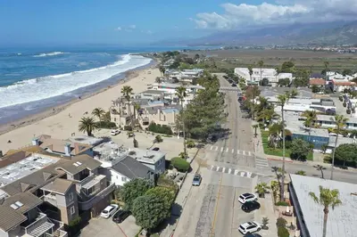 an aerial view of a beach with houses and cars at Beach Condo with Private Patio #135 in Carpinteria