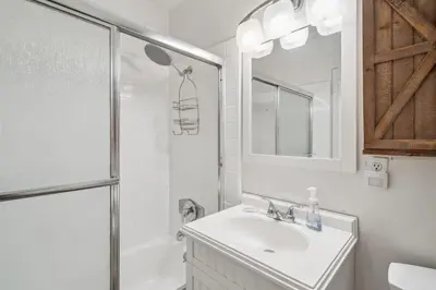 a white bathroom with a sink and a shower at Beautiful 1 Bed Beach Balcony Condo #207 in Carpinteria