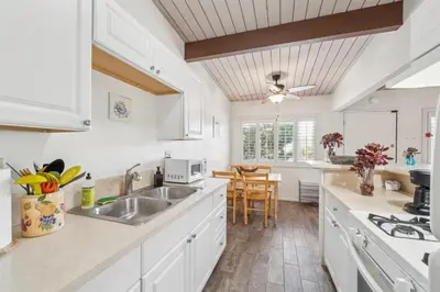 a kitchen with white cabinets and a sink at Beautiful 1 Bed Beach Condo #224 in Carpinteria