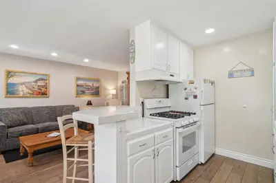 a kitchen with white cabinets and a stove top oven at Lovely 1 Bed Beach Condo #128 in Carpinteria