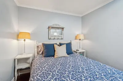 a bedroom with a blue bed with two lamps at Beach Condo with Private Ocean View Balcony #237 in Carpinteria