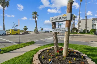 a street sign on a pole in a flower pot at 1 Bed Beach Condo #131 in Carpinteria