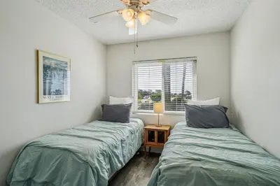 a bedroom with two beds and a ceiling fan at Beautiful 2 Bed Beach Condo #201 in Carpinteria