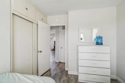 a bedroom with white cabinets and a dresser at Beautiful 2 Bed Beach Condo #201 in Carpinteria