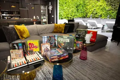 a display of books on tables in front of a couch at NEW Modern Oasis off Melrose - Rooftop - Pool in Los Angeles