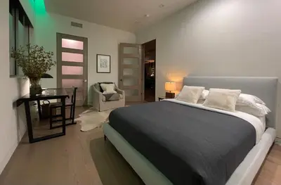 a bedroom with a bed and a table and a chair at Stunning Home - Pool & Hot Tub - Fire Pit in Los Angeles
