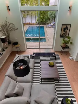 a living room with a couch and a swimming pool at Stunning Home - Pool & Hot Tub - Fire Pit in Los Angeles